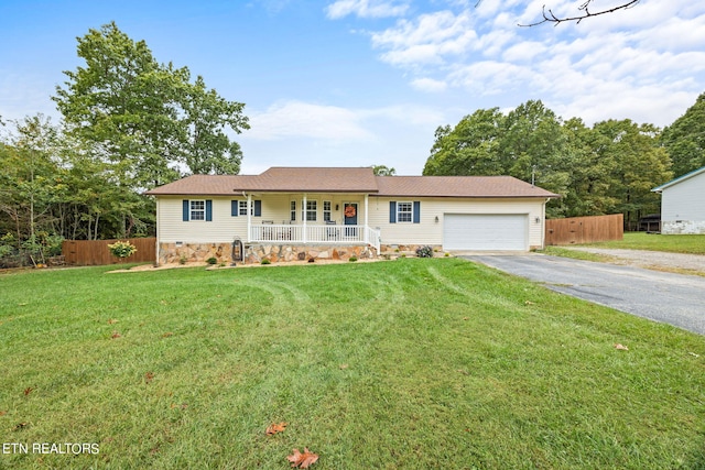 ranch-style house featuring a front lawn, a garage, and covered porch