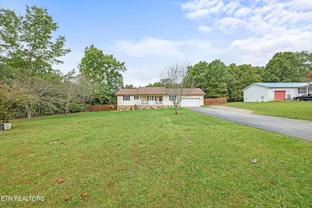 ranch-style home featuring a garage and a front yard