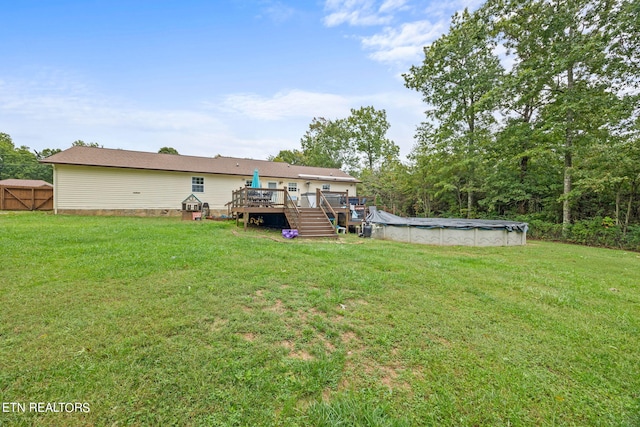 view of yard with a pool side deck