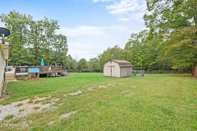 view of yard featuring a wooden deck and a shed