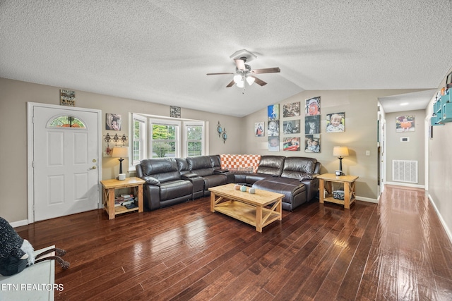 living room with ceiling fan, lofted ceiling, a textured ceiling, and dark wood-type flooring