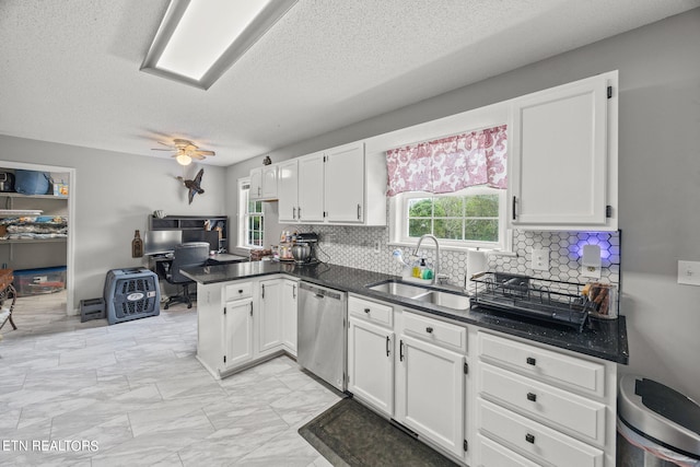 kitchen with white cabinetry, kitchen peninsula, and stainless steel dishwasher