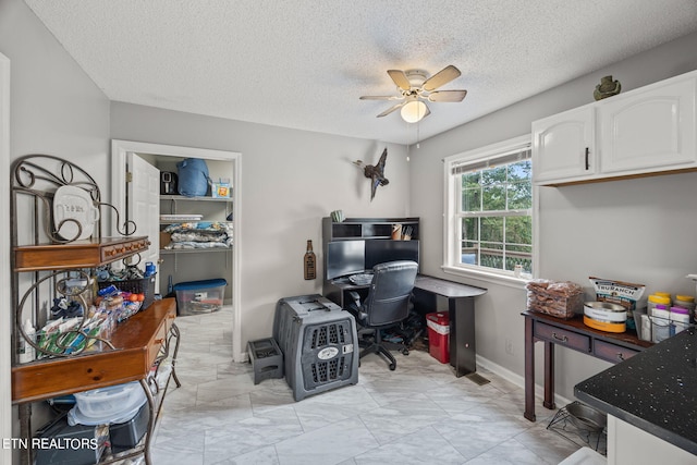 office area featuring a textured ceiling and ceiling fan