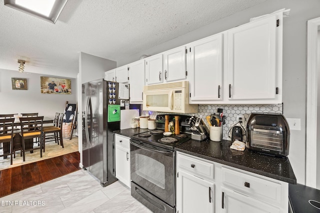 kitchen with light hardwood / wood-style floors, white cabinets, a textured ceiling, black electric range, and stainless steel refrigerator with ice dispenser