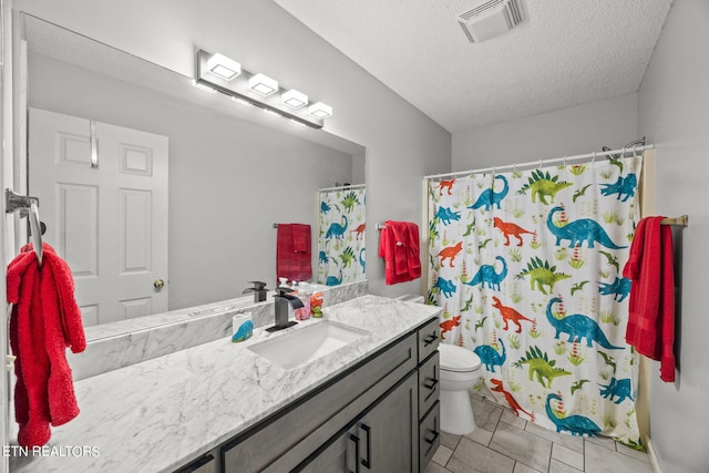 bathroom with vanity, a textured ceiling, tile patterned flooring, toilet, and a shower with curtain