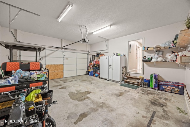 garage with white refrigerator with ice dispenser