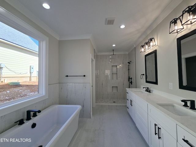 bathroom featuring a sink, visible vents, a marble finish shower, and a freestanding tub