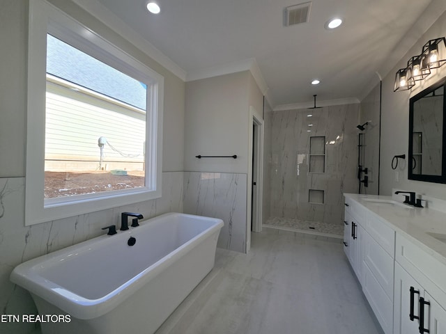 full bath with visible vents, ornamental molding, a sink, a marble finish shower, and a freestanding bath