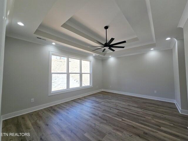 unfurnished room featuring visible vents, crown molding, and a raised ceiling