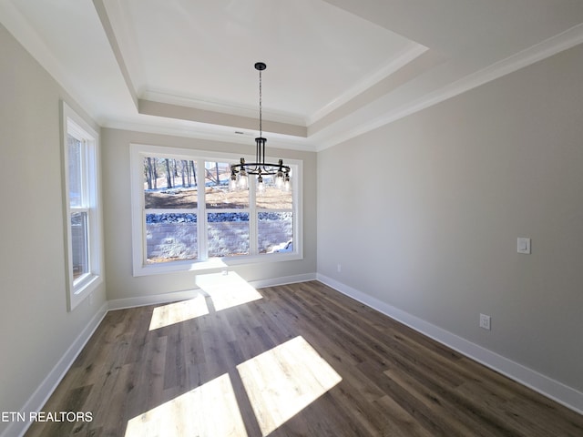 unfurnished dining area with a tray ceiling, baseboards, dark wood-type flooring, and ornamental molding