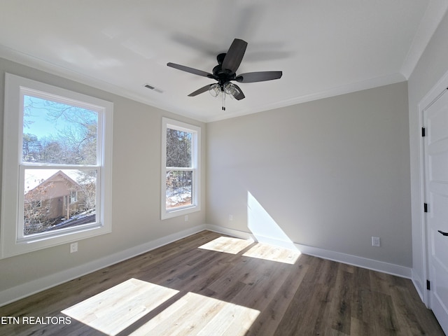 interior space with wood finished floors, visible vents, baseboards, ceiling fan, and crown molding