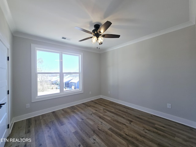 unfurnished room with dark wood finished floors, visible vents, baseboards, and ornamental molding