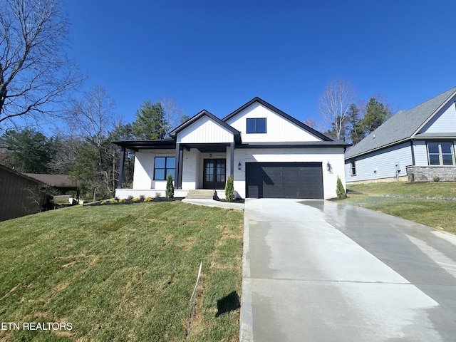 modern farmhouse style home featuring a garage, concrete driveway, and a front yard