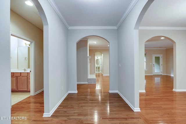 hallway featuring crown molding and light hardwood / wood-style floors