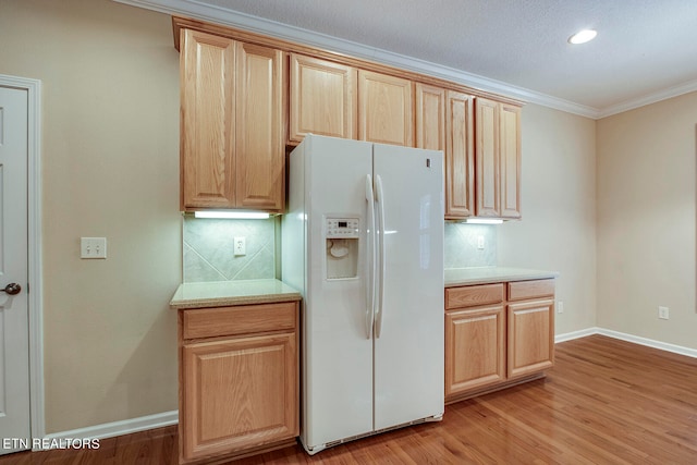 kitchen featuring white fridge with ice dispenser, crown molding, light hardwood / wood-style floors, and tasteful backsplash