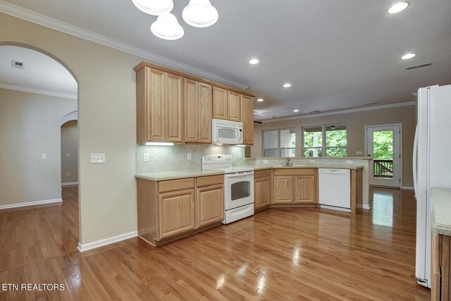 kitchen with sink, kitchen peninsula, white appliances, light hardwood / wood-style flooring, and light brown cabinetry