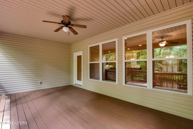 unfurnished sunroom featuring ceiling fan and wooden ceiling