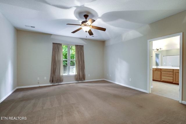 unfurnished room featuring ceiling fan and light colored carpet