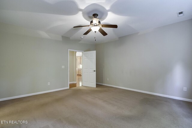 carpeted spare room featuring ceiling fan