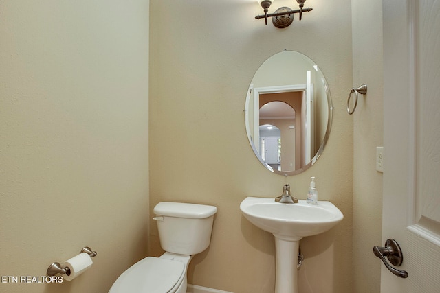 bathroom featuring sink and toilet