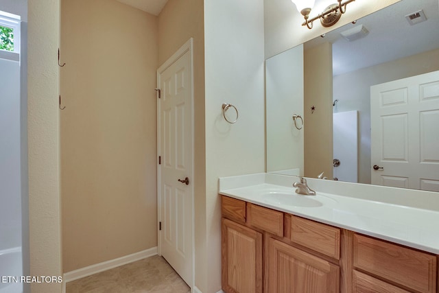 bathroom featuring tile patterned flooring and vanity