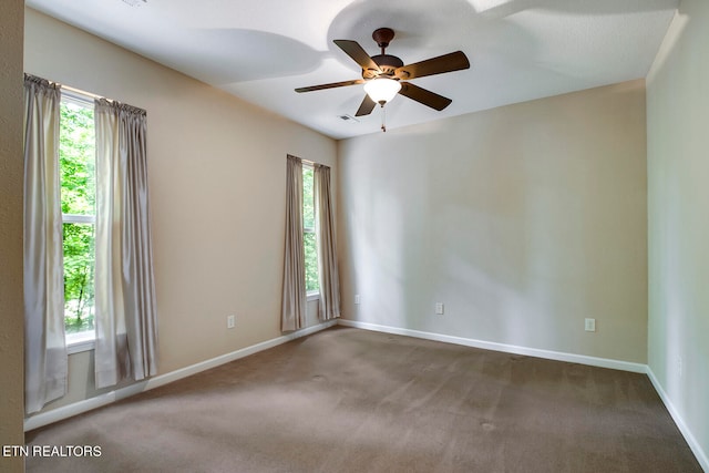 spare room featuring carpet floors and ceiling fan