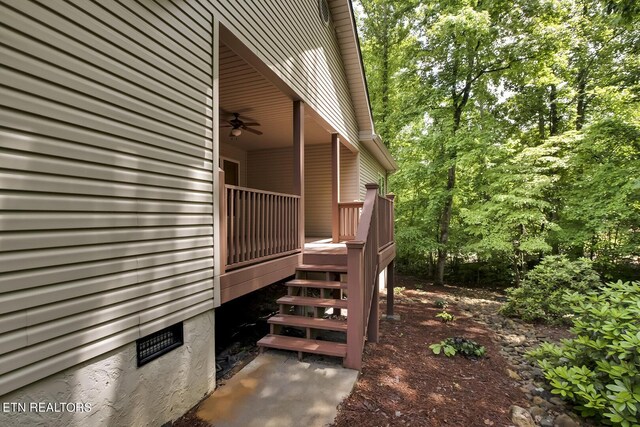 view of property exterior with ceiling fan and a wooden deck