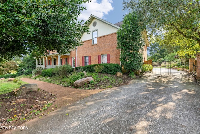 view of side of property featuring covered porch