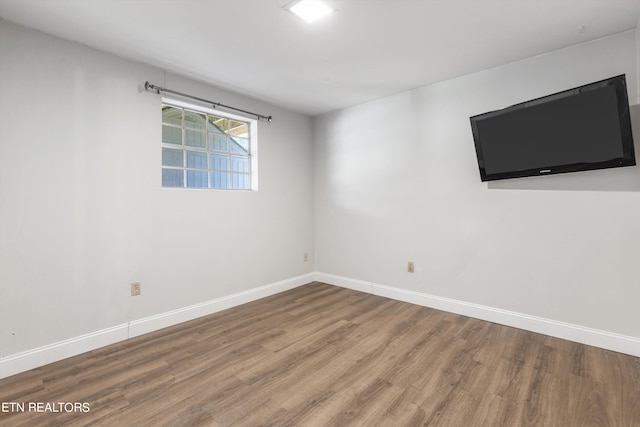 unfurnished room featuring hardwood / wood-style flooring