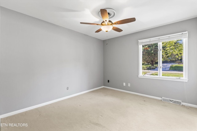 empty room featuring carpet floors and ceiling fan