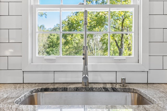 details featuring sink and stone countertops