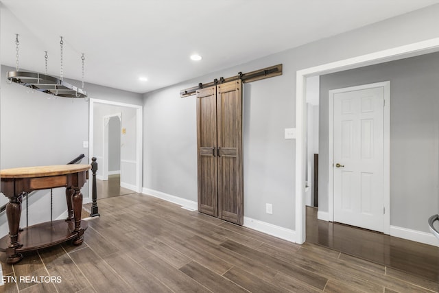 interior space featuring a barn door and hardwood / wood-style floors