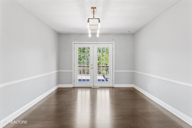 interior space featuring french doors, dark hardwood / wood-style floors, and a chandelier