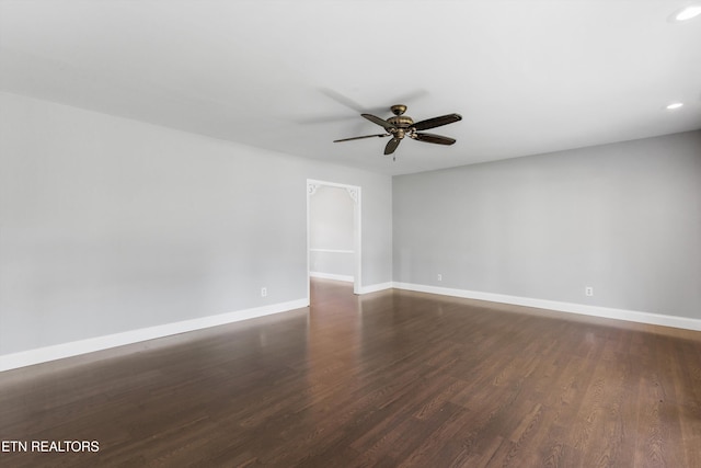 spare room featuring ceiling fan and dark hardwood / wood-style flooring