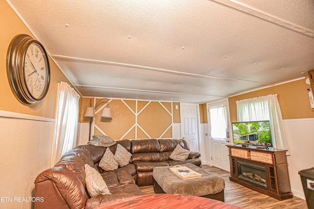 living room with hardwood / wood-style flooring and a textured ceiling