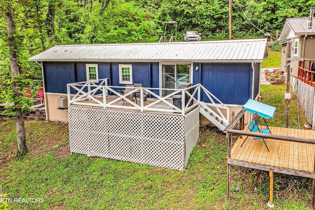 rear view of property with cooling unit