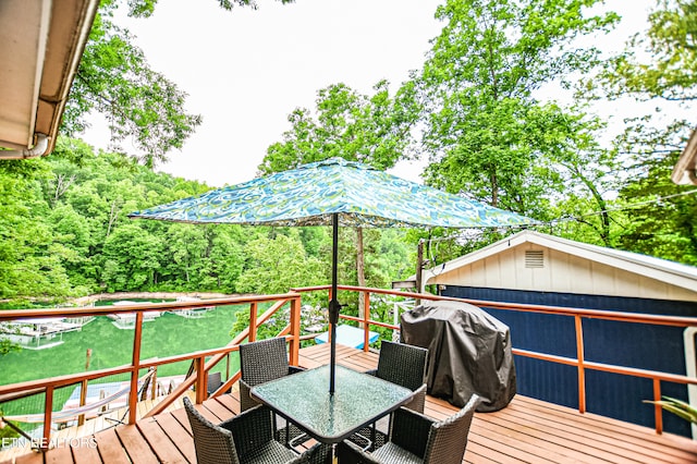 wooden deck featuring a grill