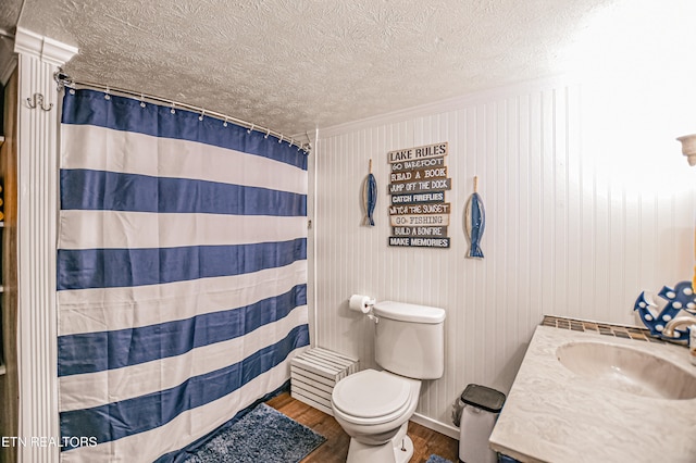 bathroom featuring curtained shower, vanity, a textured ceiling, hardwood / wood-style flooring, and toilet