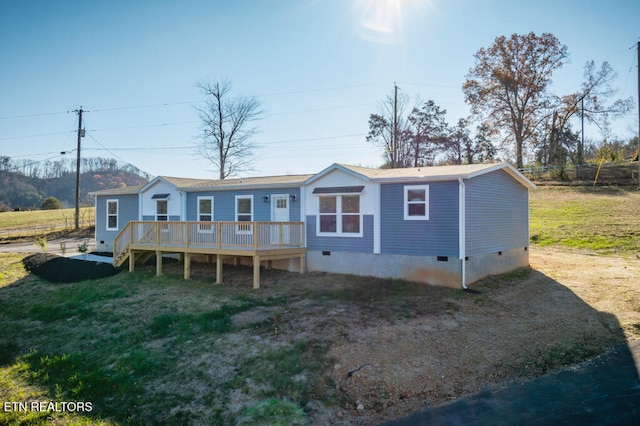 back of house with a yard and a deck