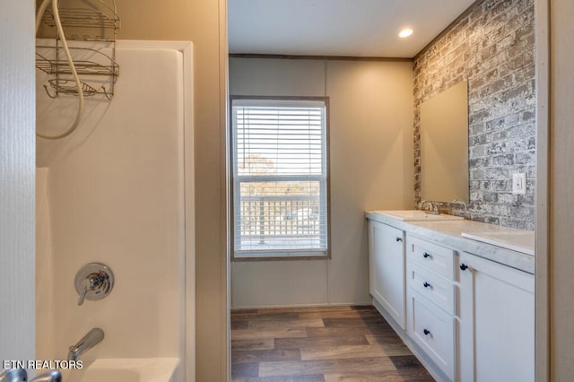 bathroom with shower / bathtub combination, vanity, and hardwood / wood-style floors