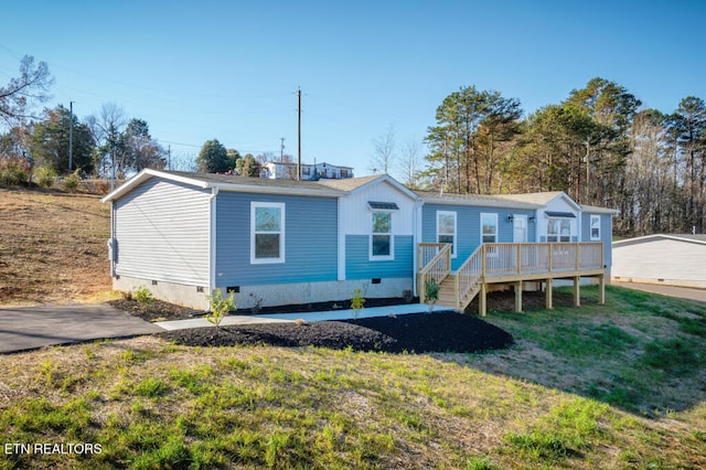 view of front of home with a wooden deck, a front yard, and crawl space