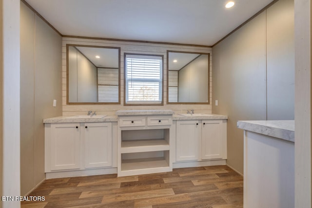 bathroom featuring a sink, wood finished floors, and double vanity