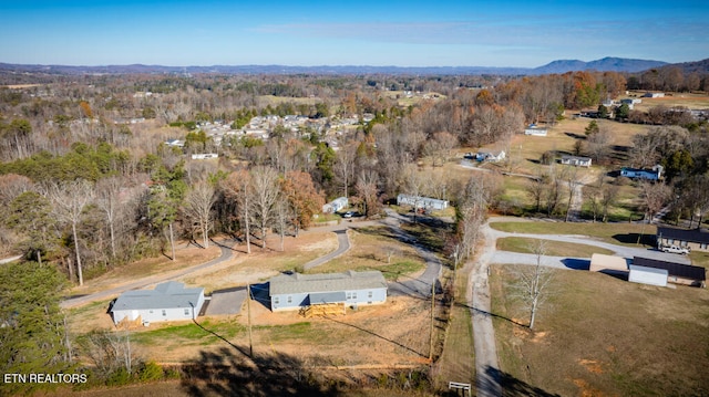 drone / aerial view with a mountain view and a forest view