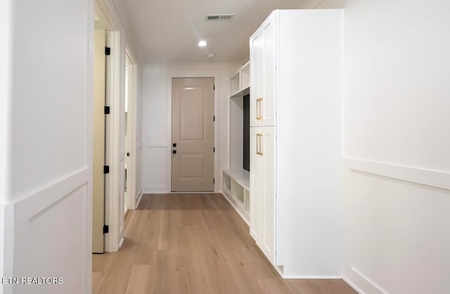 corridor with recessed lighting, visible vents, and light wood-style floors