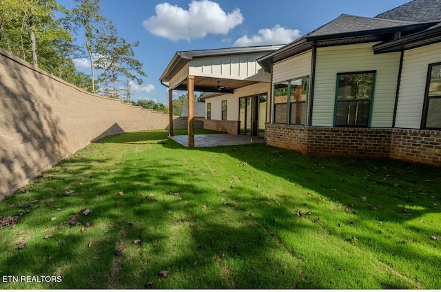 view of yard with a patio area, a ceiling fan, and a fenced backyard