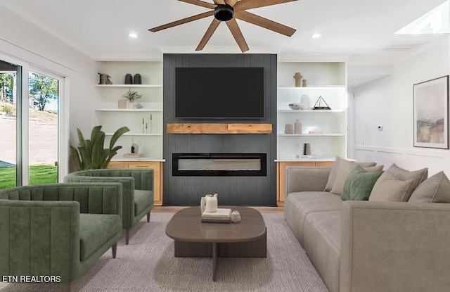 living room featuring built in features, a large fireplace, ceiling fan, and recessed lighting