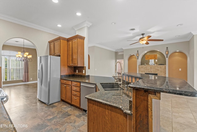 kitchen with sink, ceiling fan with notable chandelier, stainless steel appliances, decorative light fixtures, and crown molding