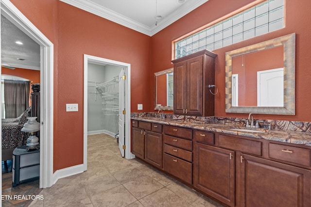 bathroom with vanity, crown molding, and tile patterned flooring