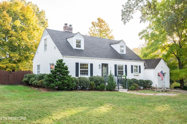 cape cod-style house with a front yard