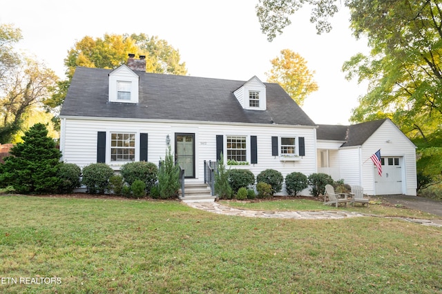 cape cod home featuring a front lawn and a garage